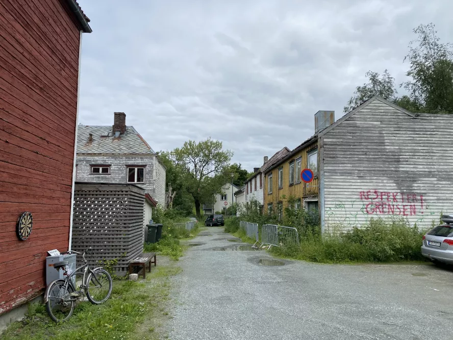 The main street pasing through Grensen. Some houses are inhabited, others falling apart.